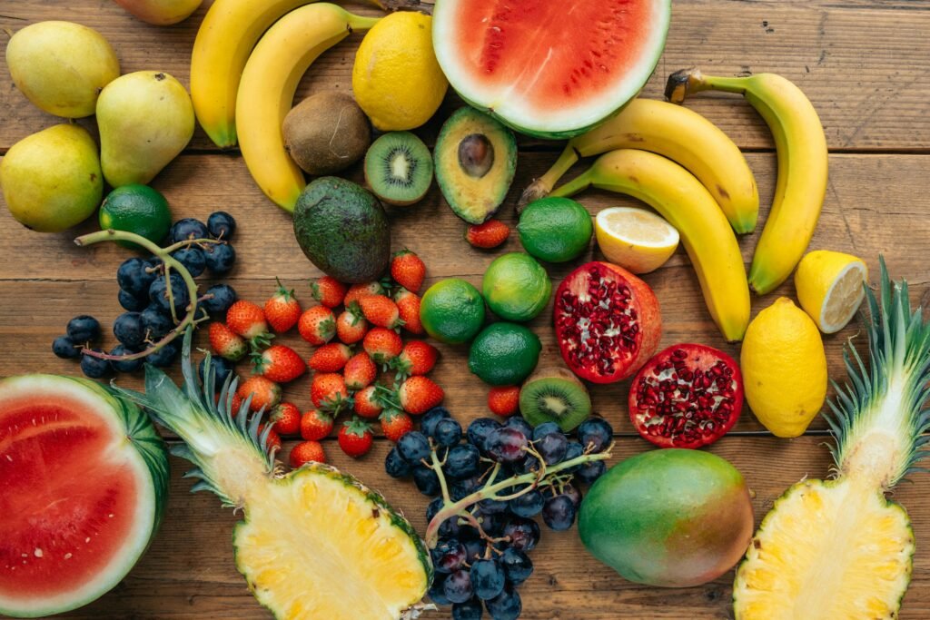 Assorted fresh fruits like kiwi, banana, mango, and pomegranate arranged aesthetically
