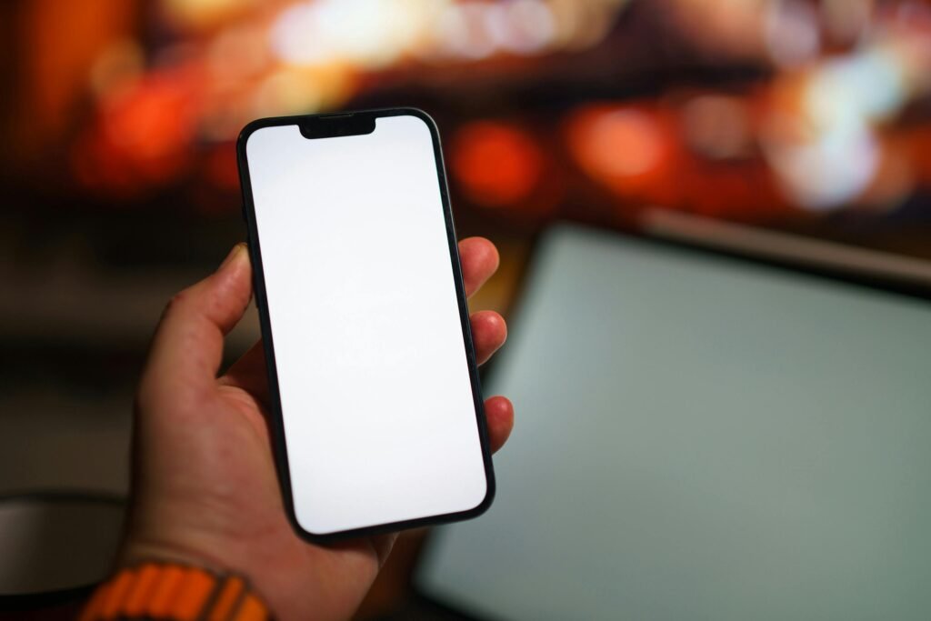 Hand holding a modern smartphone with blank screen – Top 10 features to look for before buying a phone