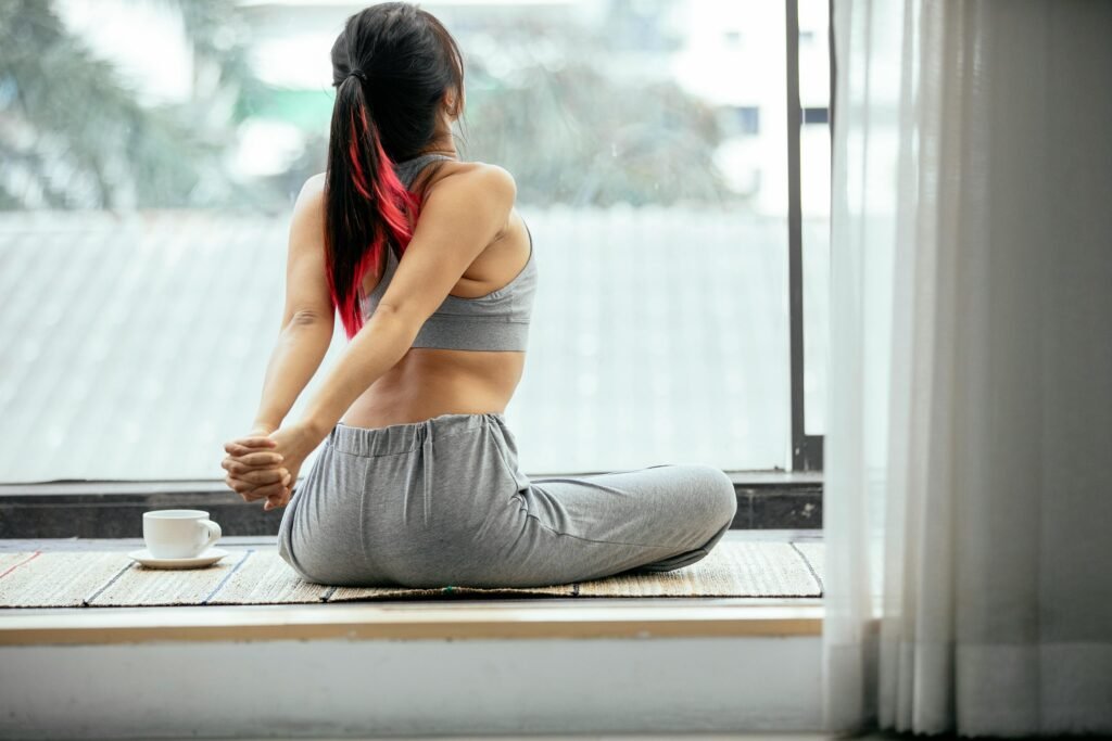 Woman stretching on a yoga mat as part of best morning routine