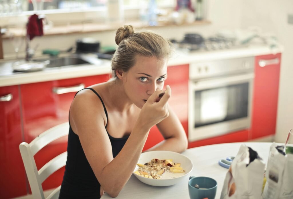 Woman eating oats and fruit for a nutritious morning start