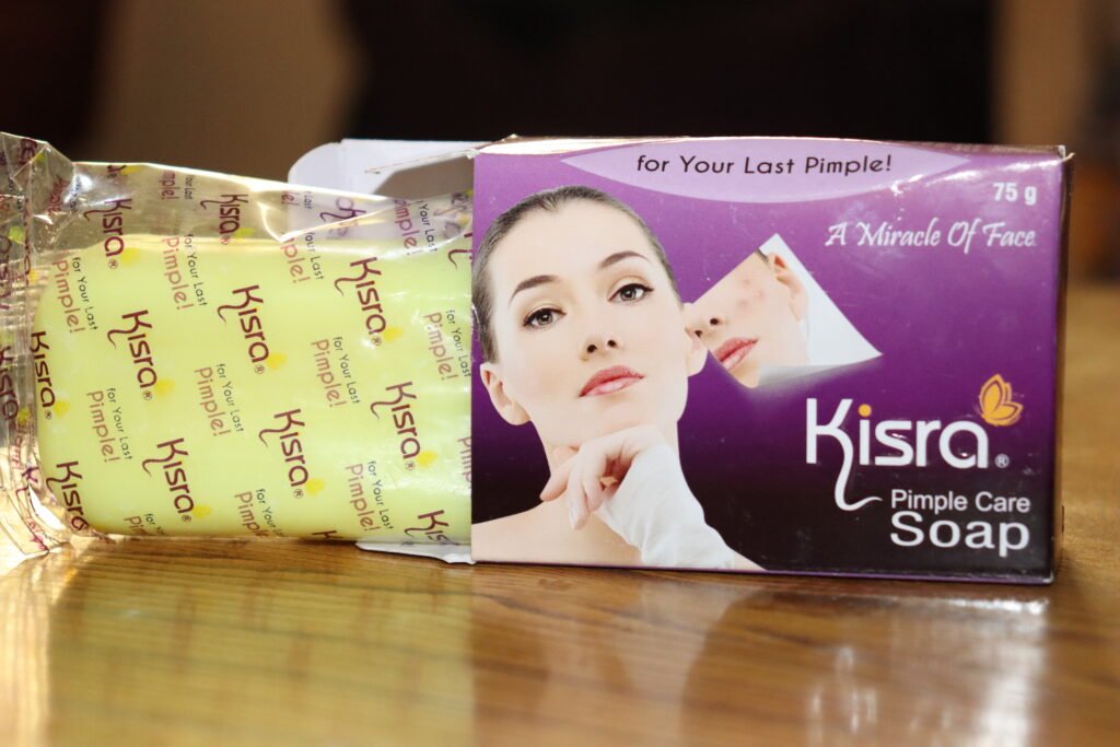 Opening the purple Kisra packaging to reveal the yellow soap bar